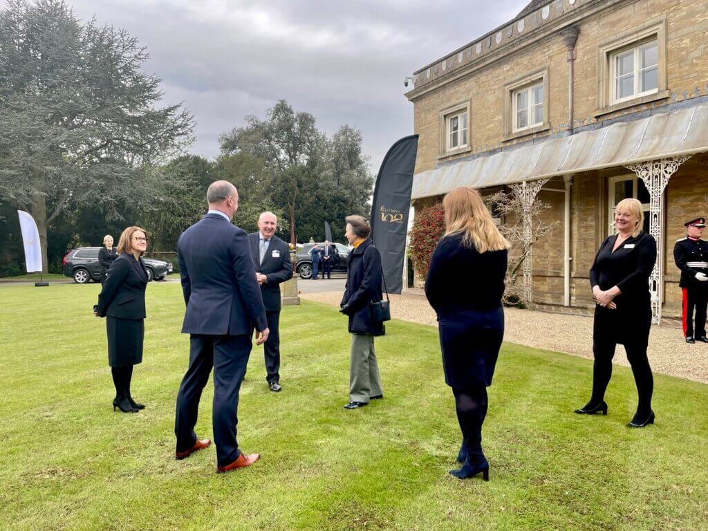 Scott Bader colleagues gathered on the grass outside of the Scott Bader UK office.